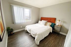 Omaha apartment for rent - a bedroom with a bed and a window