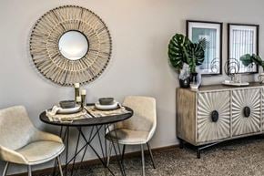 Omaha apartment for rent - a dining room with a mirror and a table with chairs