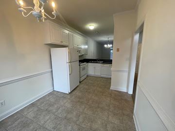 Wilson apartment for rent - A kitchen with a white refrigerator and cabinets.
