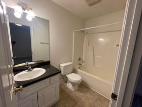 Wilson apartment for rent - A bathroom with a sink, toilet, and bathtub.