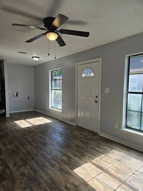 Hattiesburg apartment for rent - A room with a ceiling fan and a door.