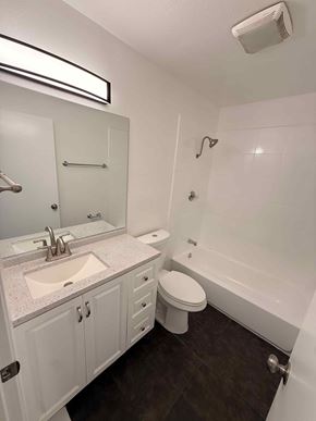 Long Beach apartment for rent - A white bathroom with a sink, toilet and bathtub.
