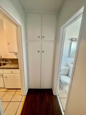 Long Beach apartment for rent - A white kitchen with a white toilet and a white cabinet.