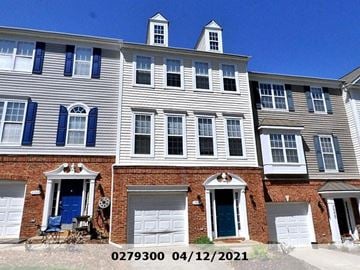 Raleigh apartment for rent - A building with a blue door and windows with shutters.