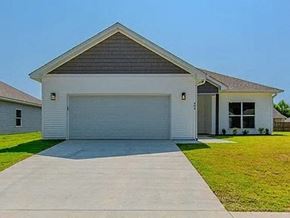 Benton house for rent - a white house with a garage door on a driveway