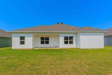 Benton house for rent - the front view of a white house with a grass yard
