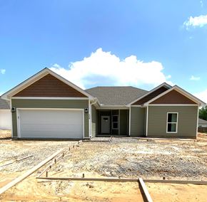 Benton house for rent - a new house being constructed with a gravel driveway and a garage door