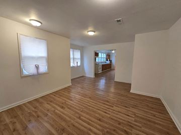 Gary house for rent - a living room and hallway with wood floors and a painting on the wall