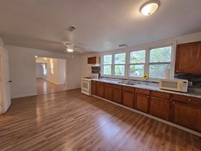 Gary house for rent - an empty kitchen with a microwave and a sink