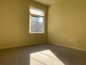 Victoria apartment for rent - A room with a window and carpeted floor.