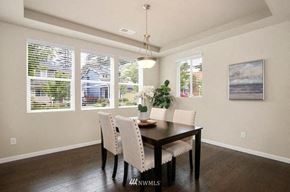Seattle house for rent - A dining room with a wooden table and chairs.