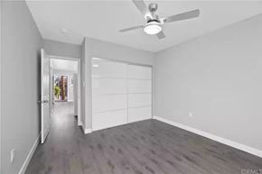 Los Angeles apartment for rent - A spacious room with a ceiling fan and a view of a hallway outside.