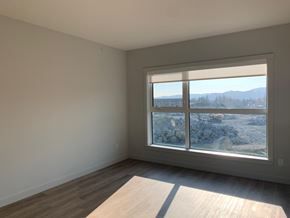 Langford apartment for rent - A room with a large window overlooking a rocky landscape.