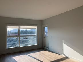 Langford apartment for rent - A room with a large window overlooking a snowy landscape.