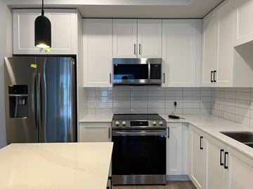 Langford apartment for rent - A modern kitchen with a black stove top oven.