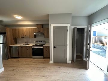 Langford apartment for rent - A kitchen with wooden cabinets and a refrigerator.