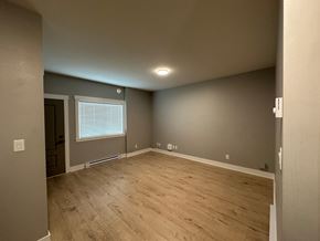 Langford apartment for rent - A room with wooden flooring and a window with blinds.