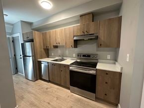 Langford apartment for rent - A kitchen with wooden cabinets and stainless steel appliances.