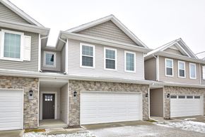 Waukee apartment for rent - A row of houses with garages on the side.