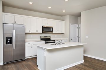Waukee apartment for rent - A kitchen with white cabinets and a stainless steel refrigerator.