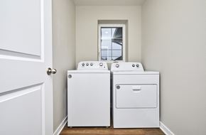 Waukee apartment for rent - Two white front load washing machines in a laundry room.