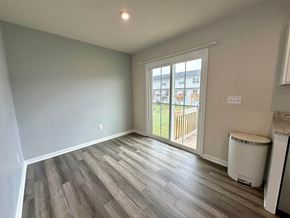 Greenville house for rent - a living room with a door to a balcony and wood flooring