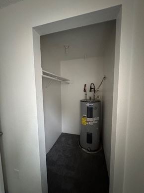 Portland apartment for rent - A small room with a water heater and a shelf.