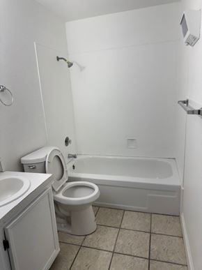 Portland apartment for rent - A white bathroom with a toilet, sink, and bathtub.
