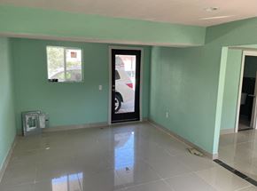 Pasadena house for rent - a living room with green walls and a white tiled floor