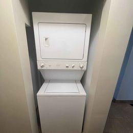 London apartment for rent - A white toilet with a closed lid and a closed seat.
