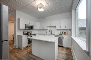 Woodstock apartment for rent - A kitchen with white cabinets and a white island.