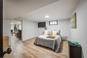 Woodstock apartment for rent - A bedroom with a bed, a chair, and a television.