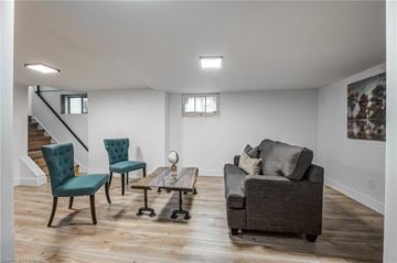 Woodstock apartment for rent - A living room with a grey couch, two chairs and a coffee table.