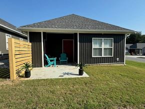 Little Rock house for rent - a small house with a patio and a wooden fence