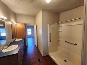 Shawnee house for rent - A bathroom with a sink, mirror, and shower.