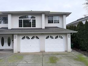 Victoria apartment for rent - A two-story house with a white garage door.