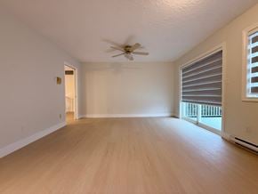 Victoria apartment for rent - A room with a ceiling fan and wooden flooring.