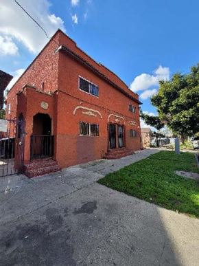 Los Angeles apartment for rent - A red brick building with a green lawn in front.