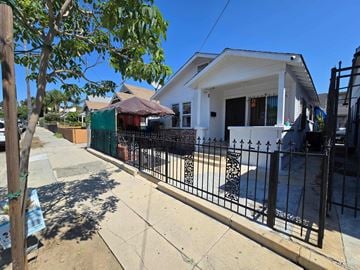 Los Angeles house for rent - A white house with a black fence in front.