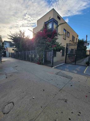 Los Angeles apartment for rent - A yellow house with a black gate in front.