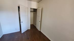 Los Angeles apartment for rent - A room with a white door and a brown floor.