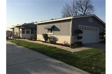 Ontario house for rent - A house with a grey roof and a white garage door.