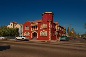 Los Angeles apartment for rent - A red building with a white car parked in front of it.