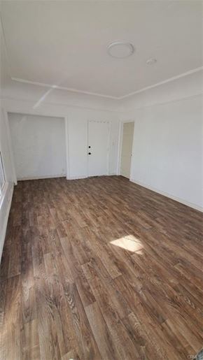 Los Angeles apartment for rent - A room with wooden flooring and white walls.