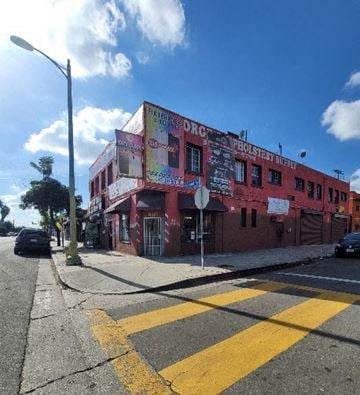 Los Angeles apartment for rent - A red building with a sign that says "DRUNKEN SCHOOL BOARD" on it.