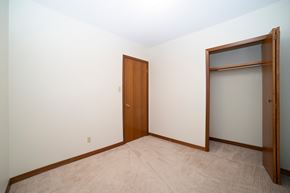 Regina apartment for rent - A room with a brown door and a white wall.