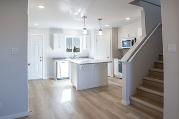 Regina apartment for rent - A modern kitchen with a staircase leading to the upper floor.