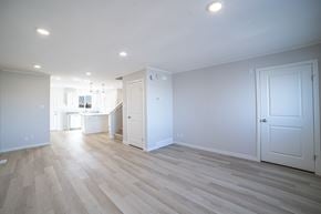 Regina apartment for rent - A spacious room with wooden flooring and white walls.