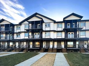 Saskatoon apartment for rent - A modern apartment complex with black and white balconies.