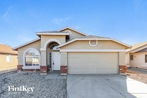 Mesa house for rent - a beige house with a white garage door
